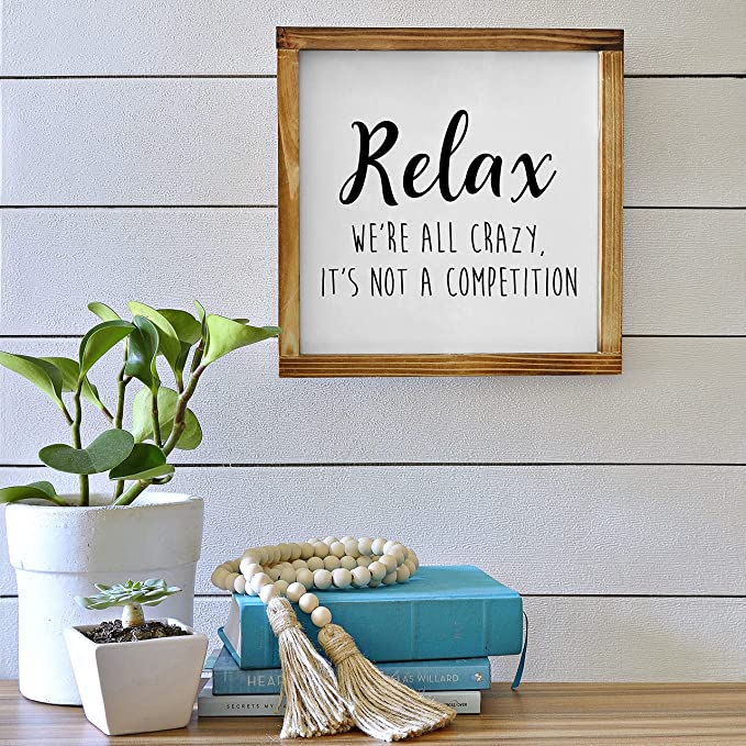 Relax We're all Crazy its not a Competition sign
